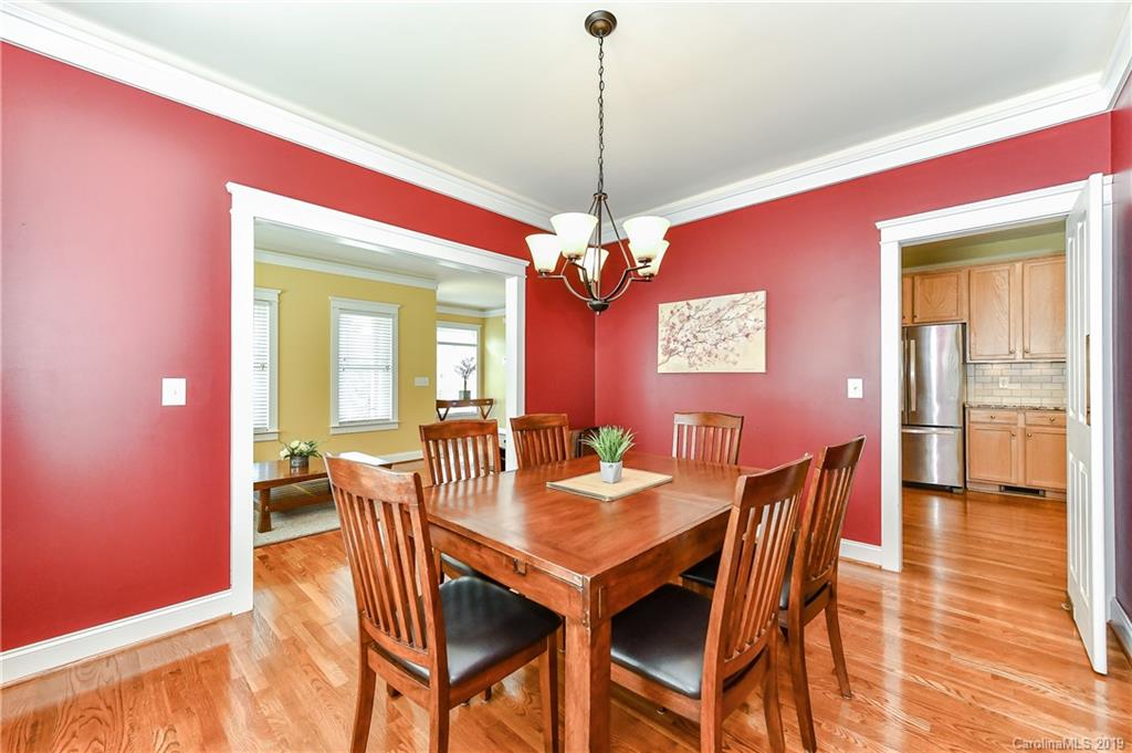 1036 Hunters Run Drive Tega Cay, SC 29708 - Photo 10 of 35 a dining room with furniture a chandelier and wooden floor