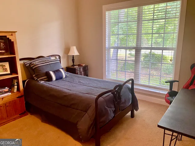a bed sitting in a bedroom next to a window