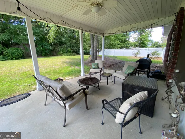 a building outdoor space with patio furniture and garden