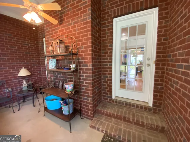 a view of a patio with table and chairs and potted plants