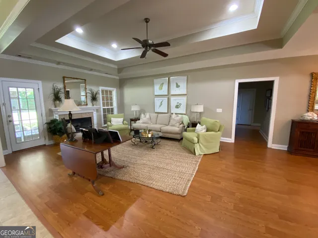 a living room with furniture and a wooden floor