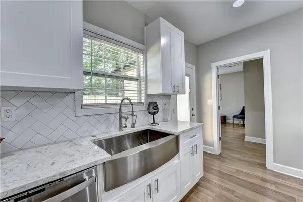 a kitchen with a sink cabinets and window