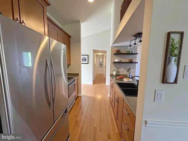 a kitchen with stainless steel appliances a refrigerator a stove a sink and dishwasher