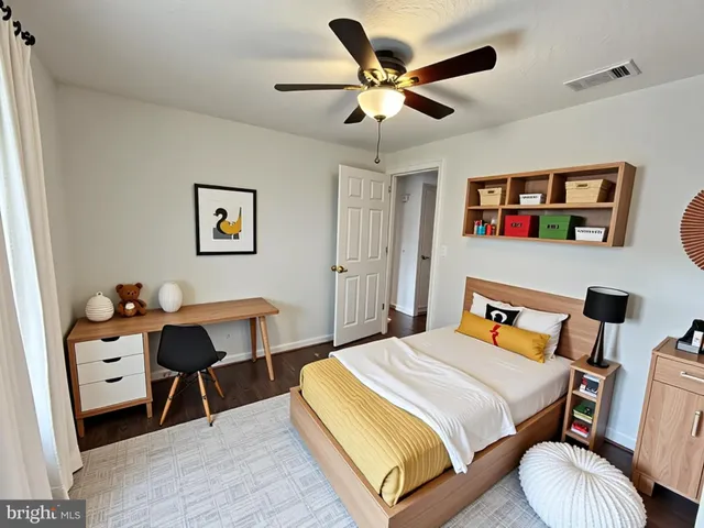 a bedroom with a bed and a desk