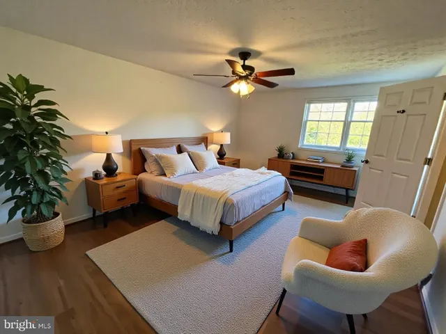 a bedroom with a bed a chandelier and a couch