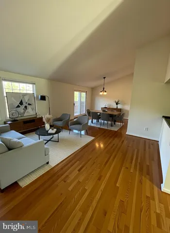 a kitchen view with a sink and living room view