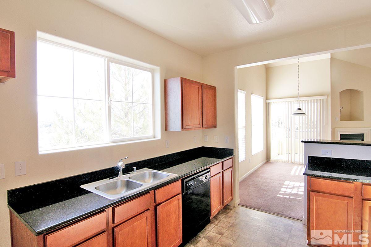 9050 Double R, Unit 225 Reno, NV 89521 - Photo 12 of 29 a kitchen with granite countertop a sink and a stove
