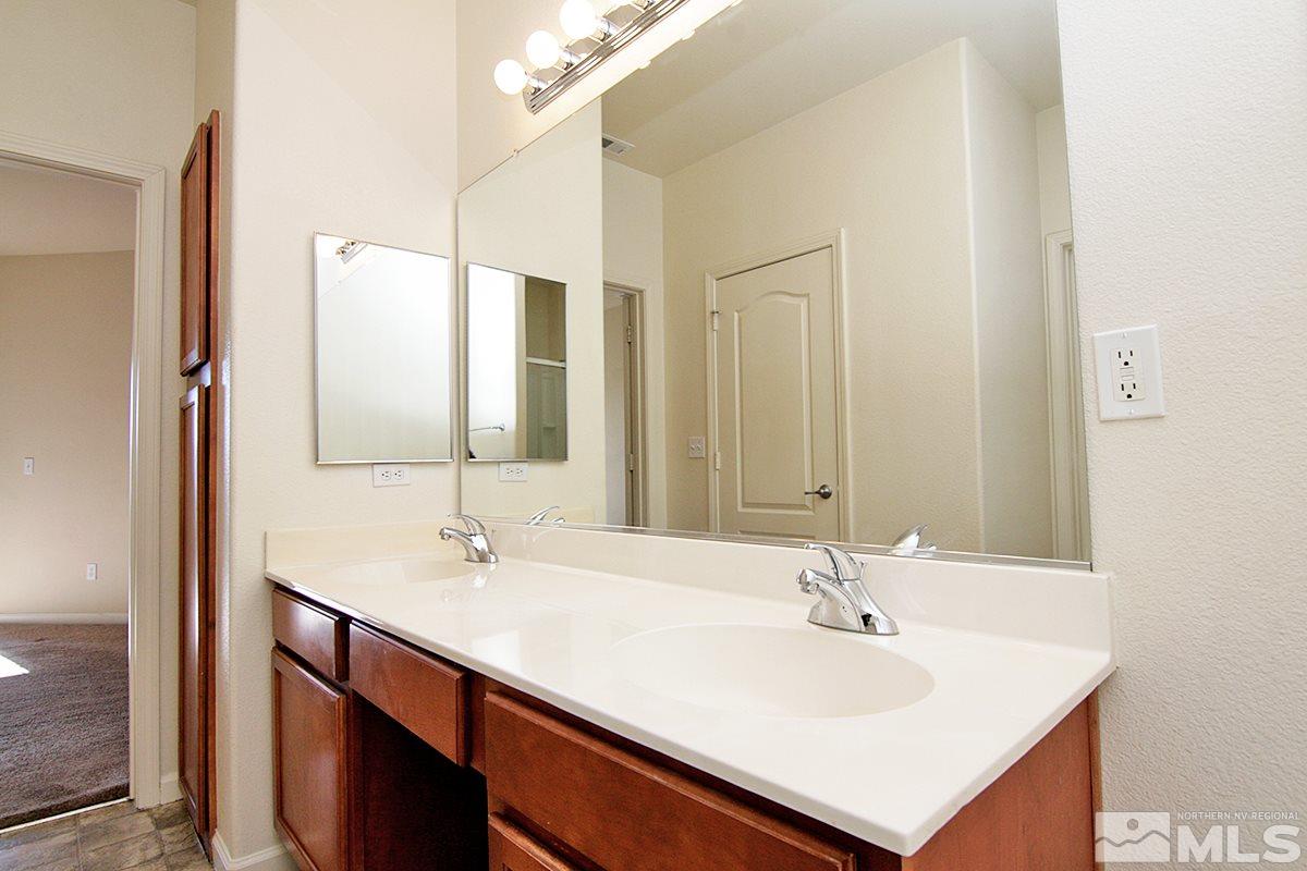 9050 Double R, Unit 225 Reno, NV 89521 - Photo 15 of 29 a bathroom with a sink and a mirror