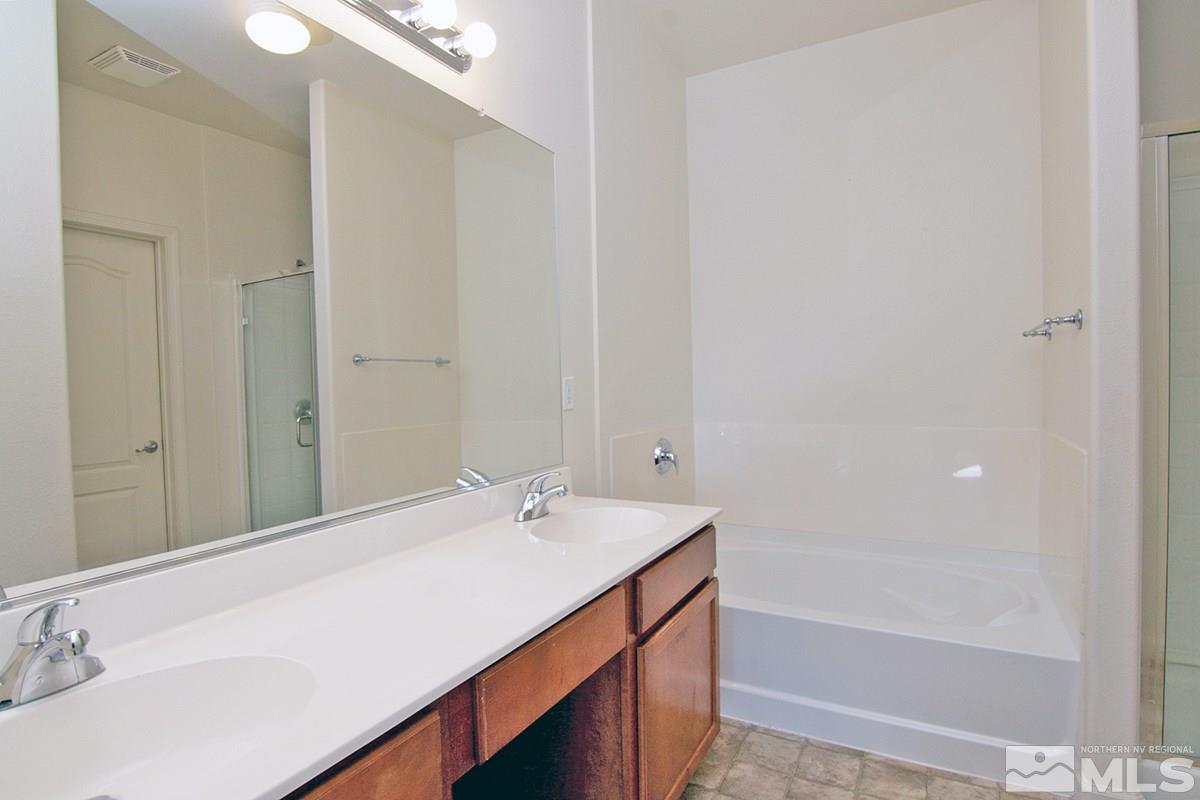 9050 Double R, Unit 225 Reno, NV 89521 - Photo 19 of 29 a bathroom with a sink and a bathtub