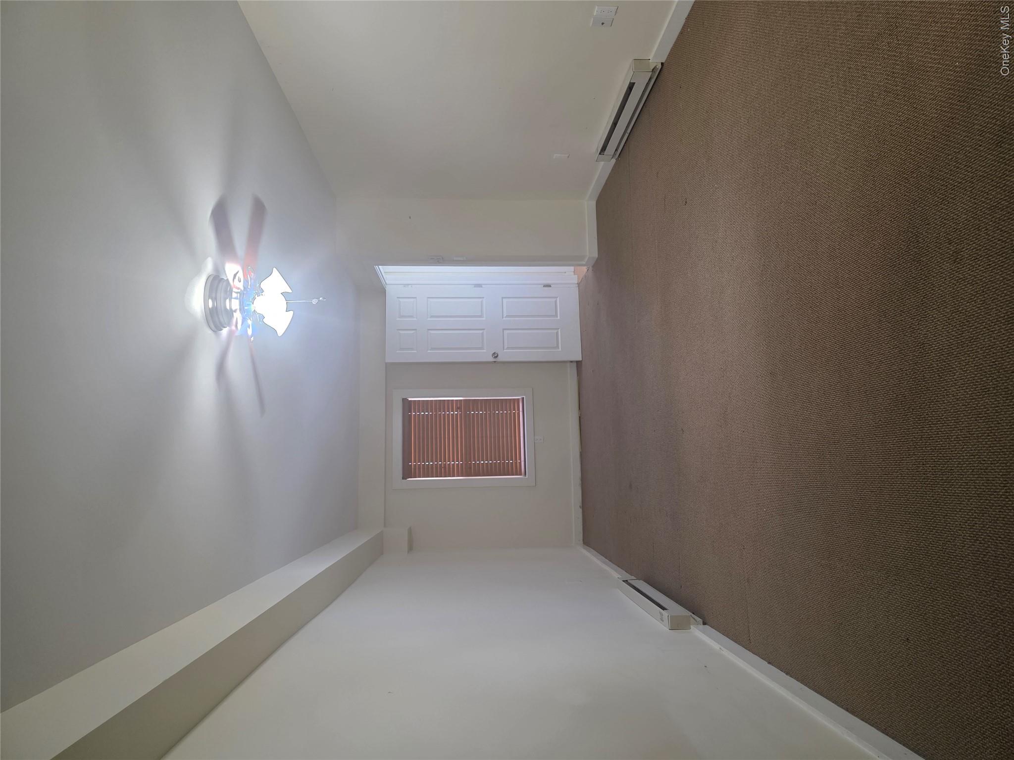 231 Reynolds Road, Unit 11 Loch Sheldrake, NY 12759 - Photo 11 of 20 Carpeted empty room with baseboard heating and baseboards