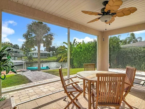 a view of a patio with a table chairs and a backyard