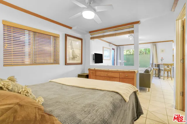 a bedroom with a large bed and a large window