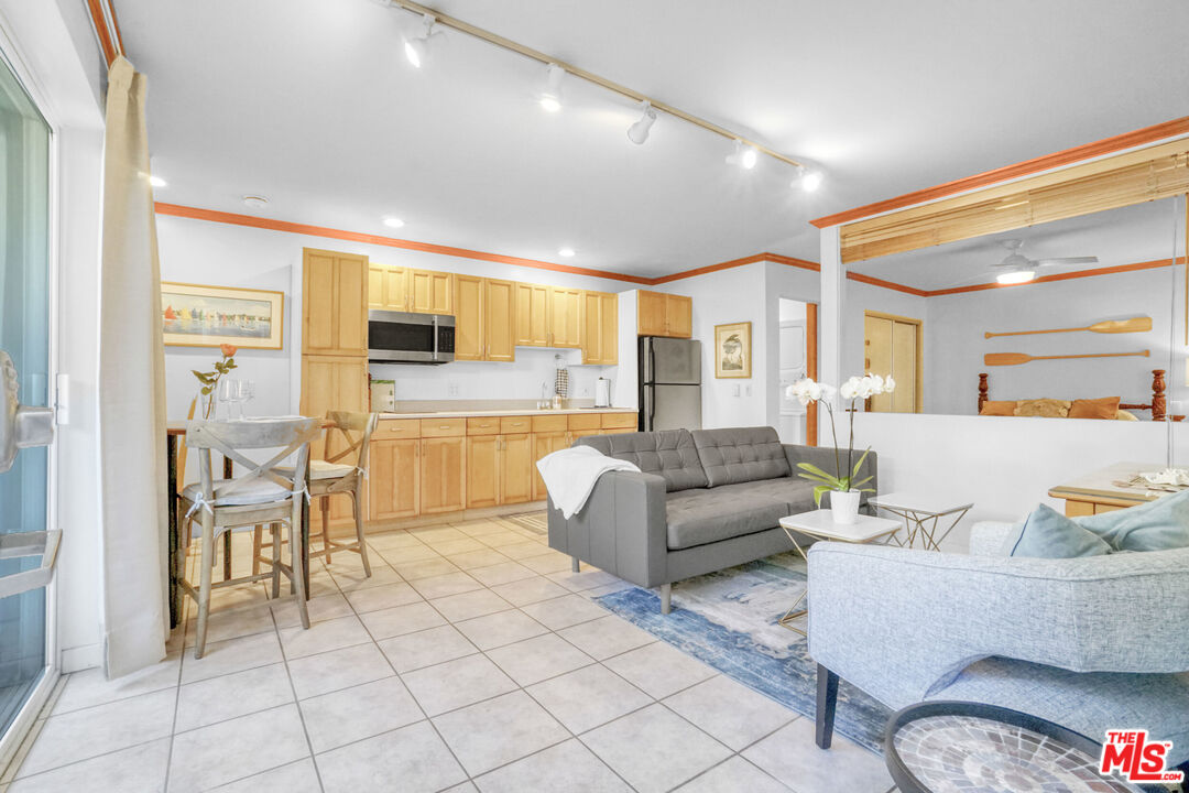 120 Fleet Street, Unit C Marina del Rey, CA 90292 - Photo 13 of 23 a living room with furniture and a dining table with kitchen view