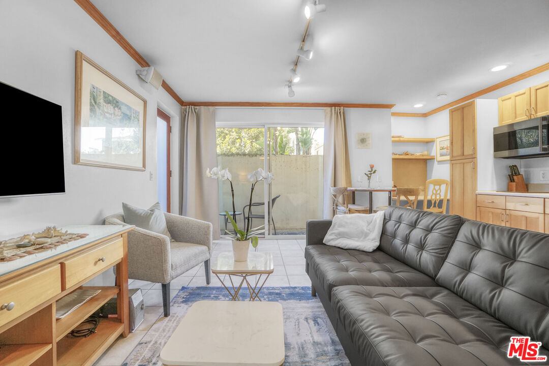 120 Fleet Street, Unit C Marina del Rey, CA 90292 - Photo 15 of 23 a living room with furniture flat screen tv and large window