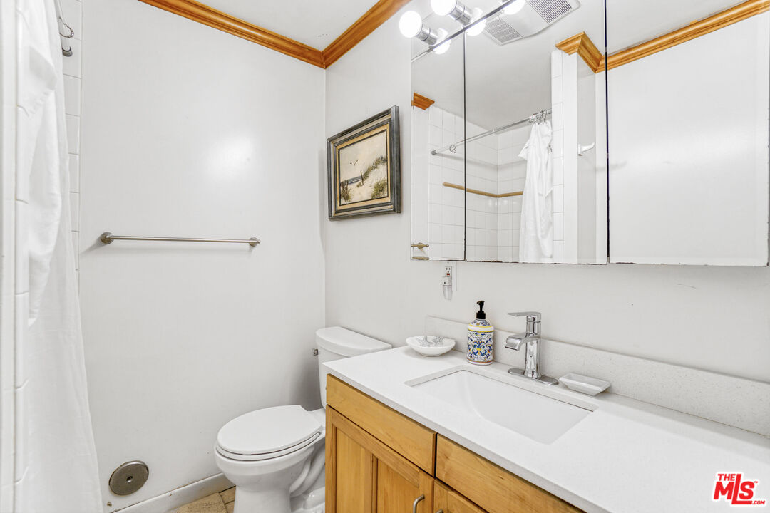 120 Fleet Street, Unit C Marina del Rey, CA 90292 - Photo 7 of 23 a bathroom with a granite countertop sink mirror vanity and toilet