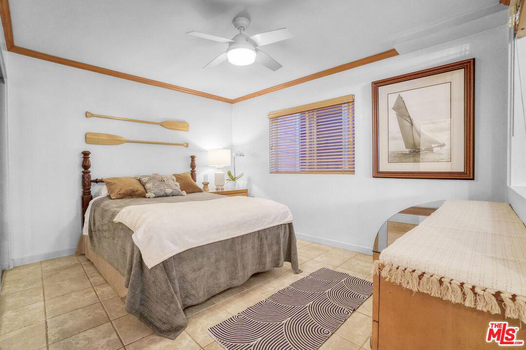 120 Fleet Street, Unit C Marina del Rey, CA 90292 - Photo 8 of 23 a bedroom with a bed and a chandelier