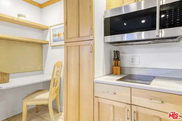 a kitchen with a refrigerator and cabinets