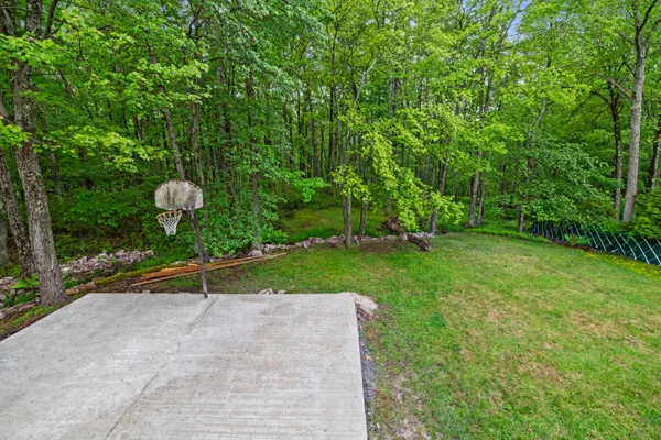 a kitchen with a refrigerator a stove a microwave and island with wooden floor