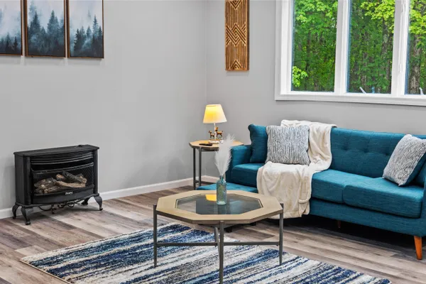 a kitchen with stainless steel appliances granite countertop a stove a sink a microwave a refrigerator and white cabinets