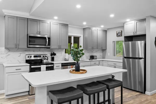 a bed room with a bed and a painting on the wall