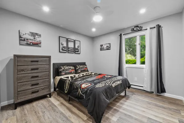 a view of a house with a yard and large tree