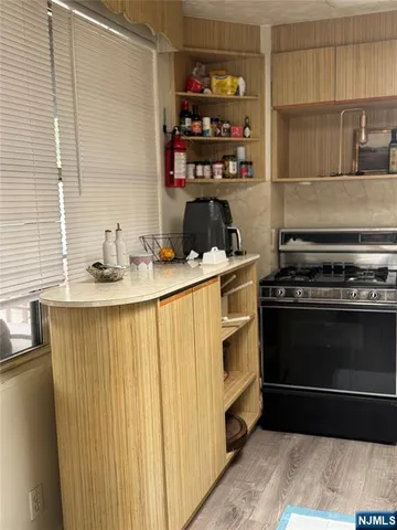 a kitchen with a stove and a refrigerator