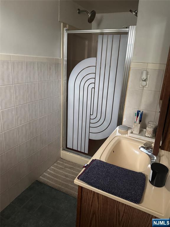 89 Ivy Street Kearny, NJ 07032 - Photo 12 of 14 a room with a sink and a mirror