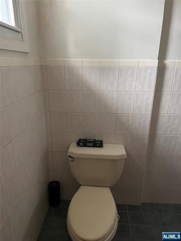 89 Ivy Street Kearny, NJ 07032 - Photo 13 of 14 a white toilet sitting next to a bathroom sink