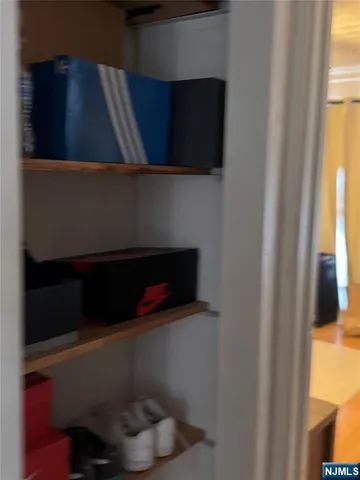 a shelf with books and a window