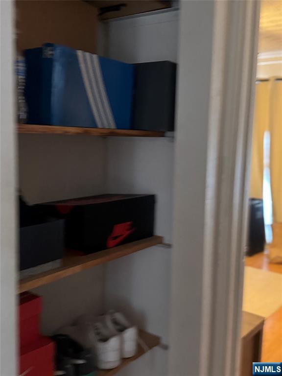 89 Ivy Street Kearny, NJ 07032 - Photo 4 of 14 a shelf with books and a window