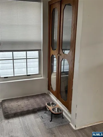 a room with a wooden floor and a window