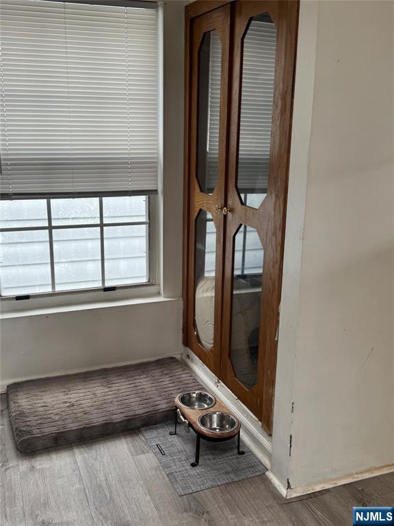 89 Ivy Street Kearny, NJ 07032 - Photo 8 of 14 a room with a wooden floor and a window