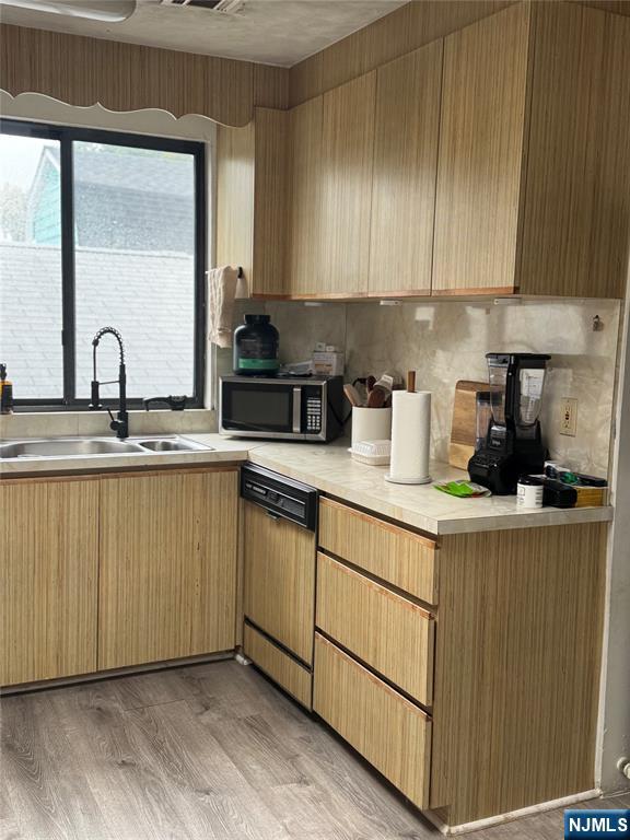 89 Ivy Street Kearny, NJ 07032 - Photo 10 of 14 a kitchen with granite countertop a sink a stove and cabinets