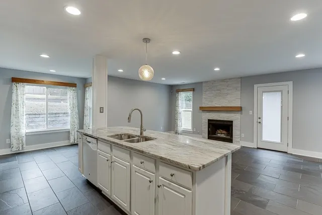 a kitchen with granite countertop a sink and a stove