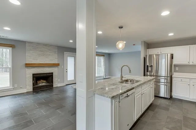 a kitchen with a refrigerator and a stove top oven