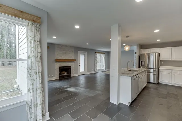 a view of a kitchen with a sink and refrigerator