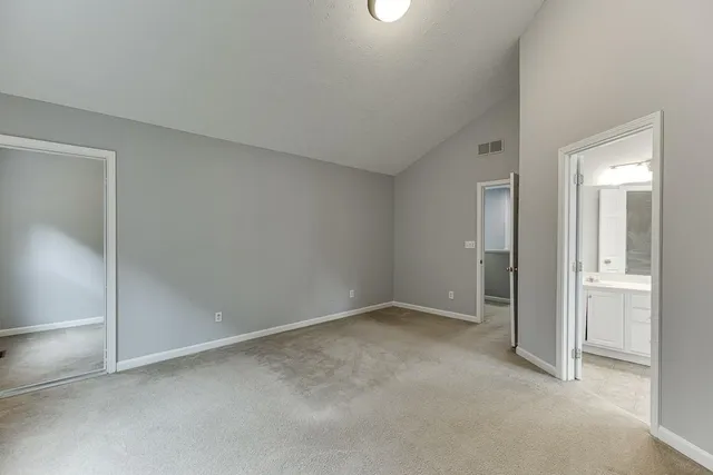 a view of an empty room and closet area