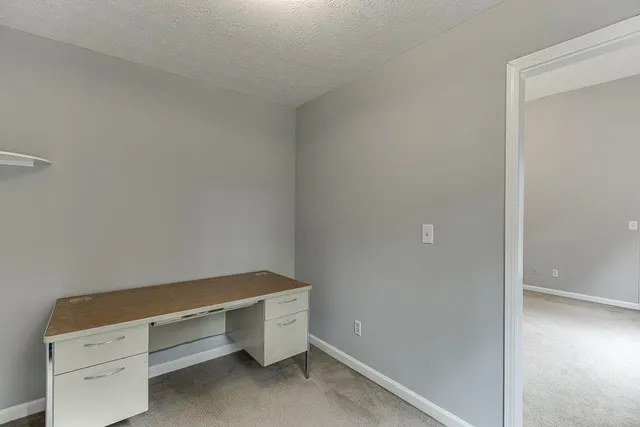a bathroom with a tub a sink and mirror