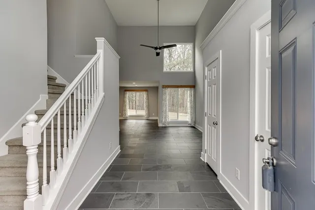 a view of a hallway with windows and stairs