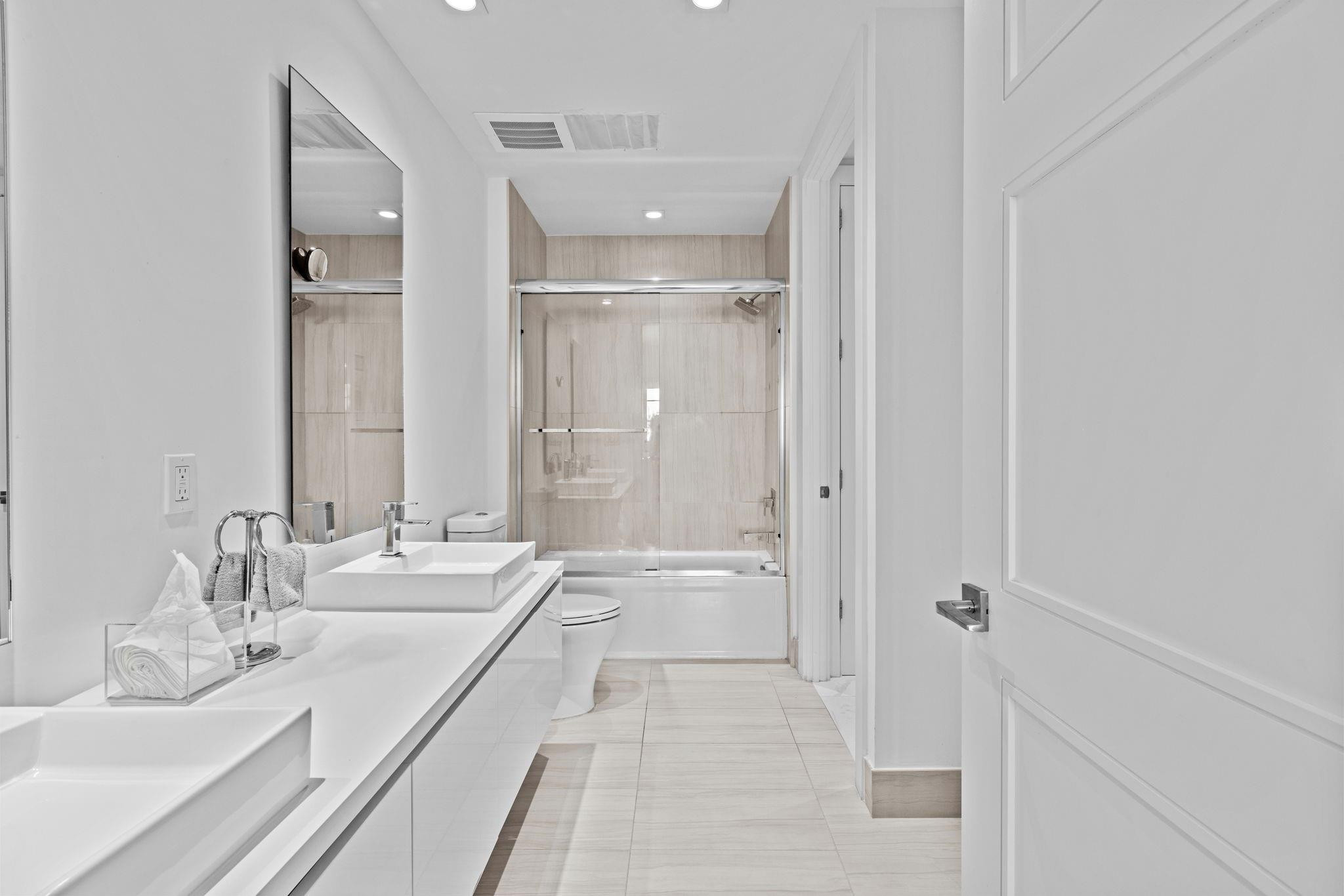 155 East Boca Raton Road, Unit 417 Boca Raton, FL 33432 - Photo 17 of 32 a bathroom with a granite countertop sink mirror and a bathtub