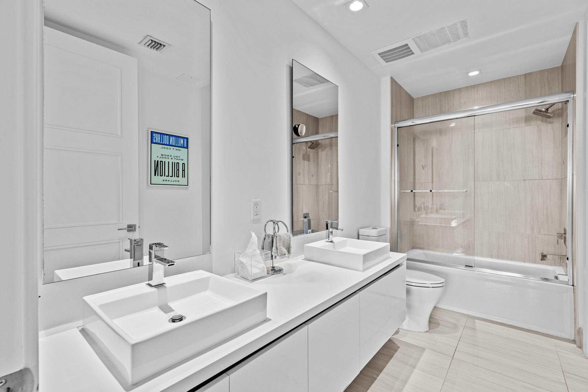 155 East Boca Raton Road, Unit 417 Boca Raton, FL 33432 - Photo 18 of 32 a bathroom with double vanity sinks double vanity tub and shower