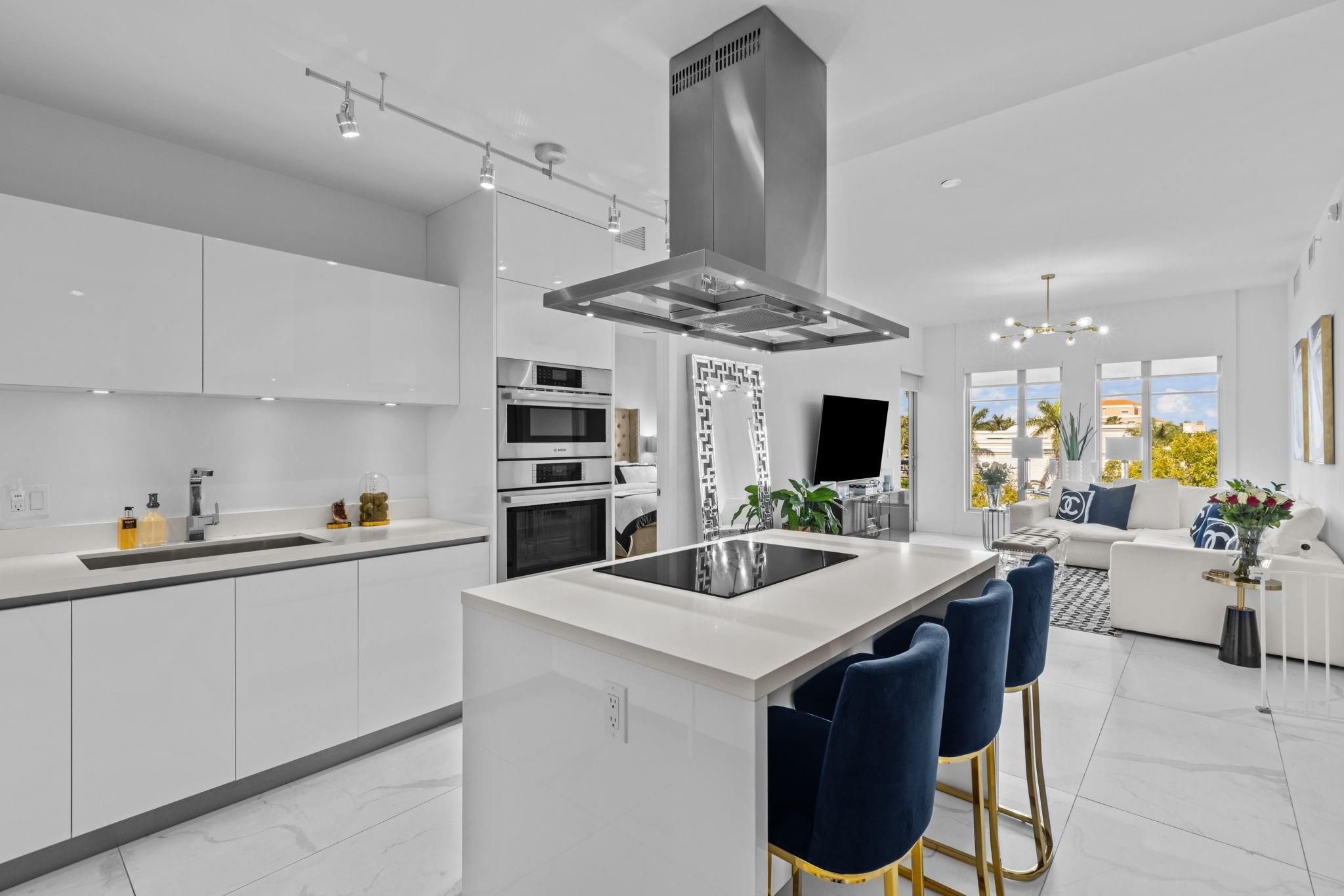 155 East Boca Raton Road, Unit 417 Boca Raton, FL 33432 - Photo 2 of 32 a kitchen with stainless steel appliances kitchen island granite countertop a sink and cabinets