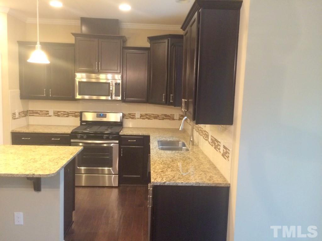 3916 Cary, NC 27519 - Photo 8 of 16 a kitchen with stainless steel appliances granite countertop a sink and a stove