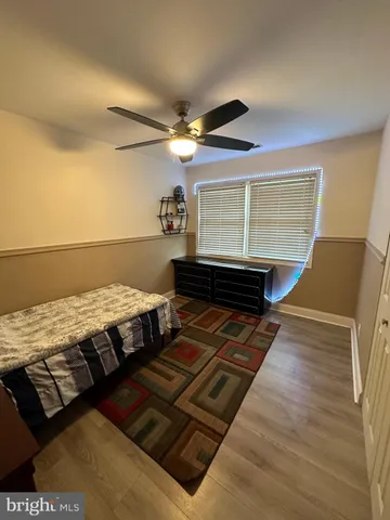 a bedroom with a bed dresser and a window