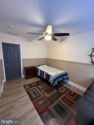 a bedroom with a bed and a ceiling fan