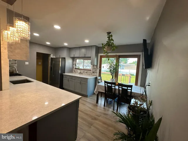 a kitchen with dining table and chandelier