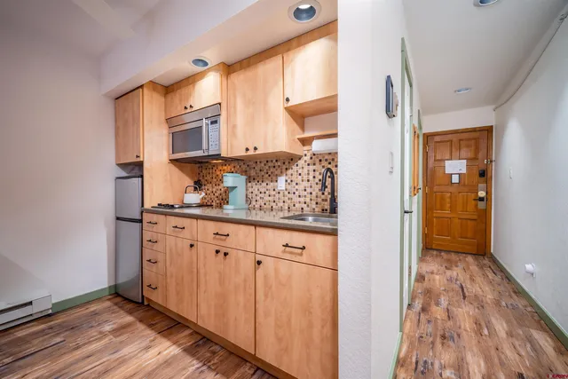 a view of cabinets and wooden floor