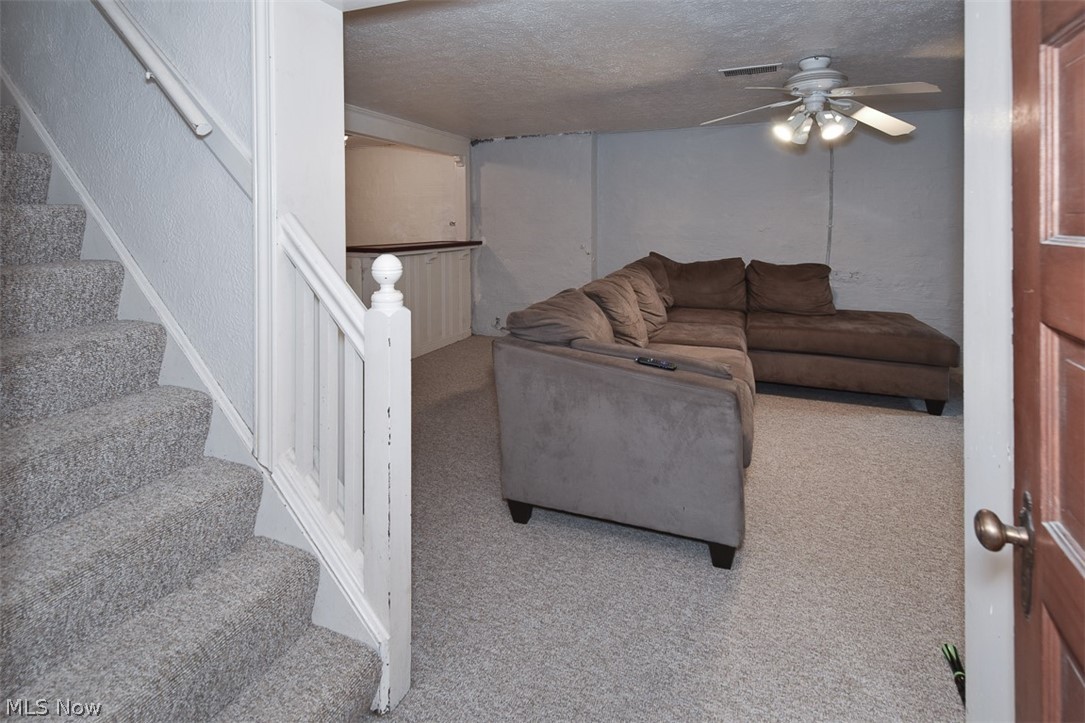 2559 Channing Road Cleveland, OH 44118 - Photo 23 of 28 Carpeted living room featuring a textured ceiling and ceiling fan