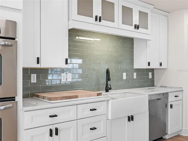a kitchen with a sink stove and cabinets