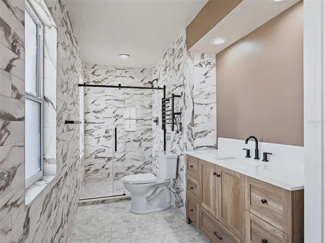 a bathroom with a toilet sink and shower